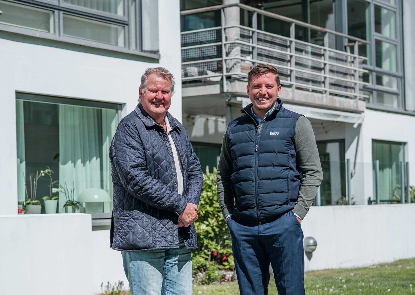 Styrelsemedlem i BRF Treudden och säljare från Öresundskraft framför bostadsrättsföreningen.