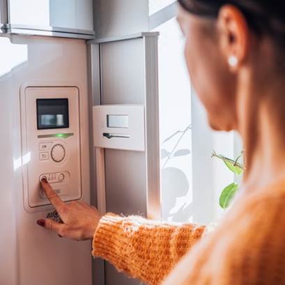 Kvinna som står vid värmepump